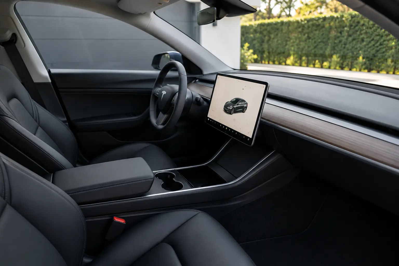 Clean, fresh car interior with black seats and a large screen.