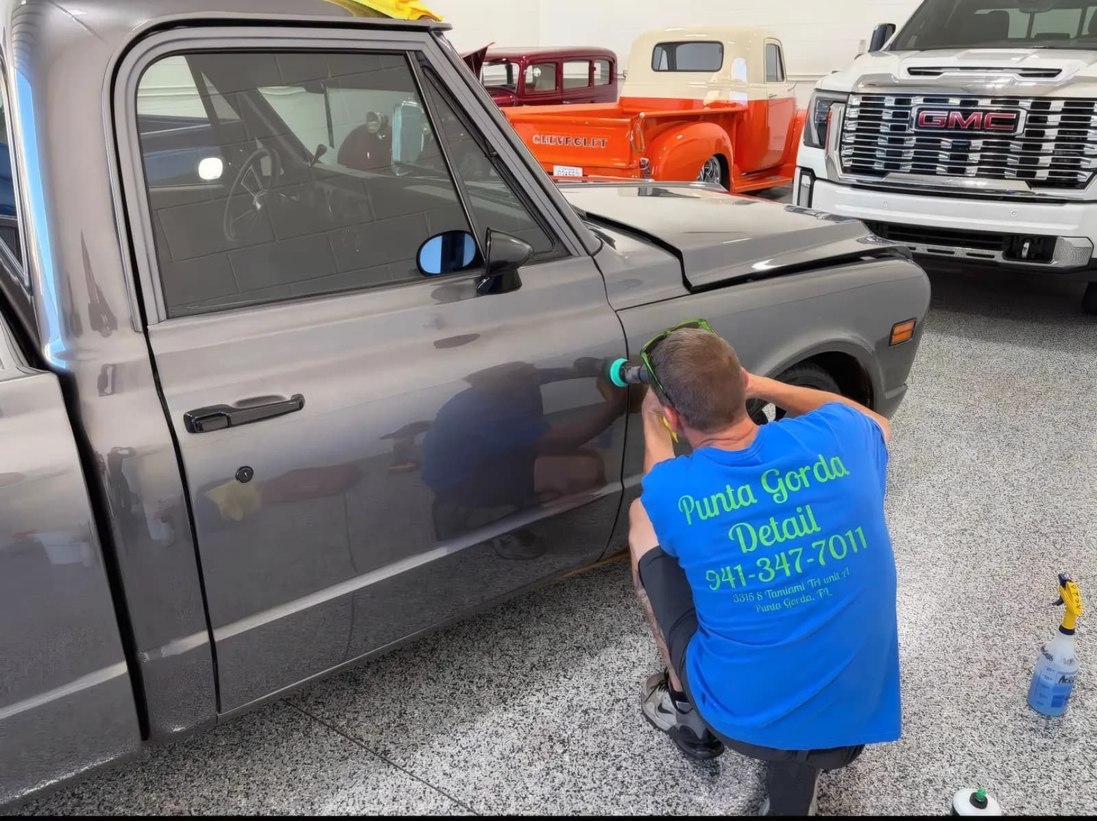 Punta Gorda Detail detailer machine polishing the door of a grey classic Chevy pickup.