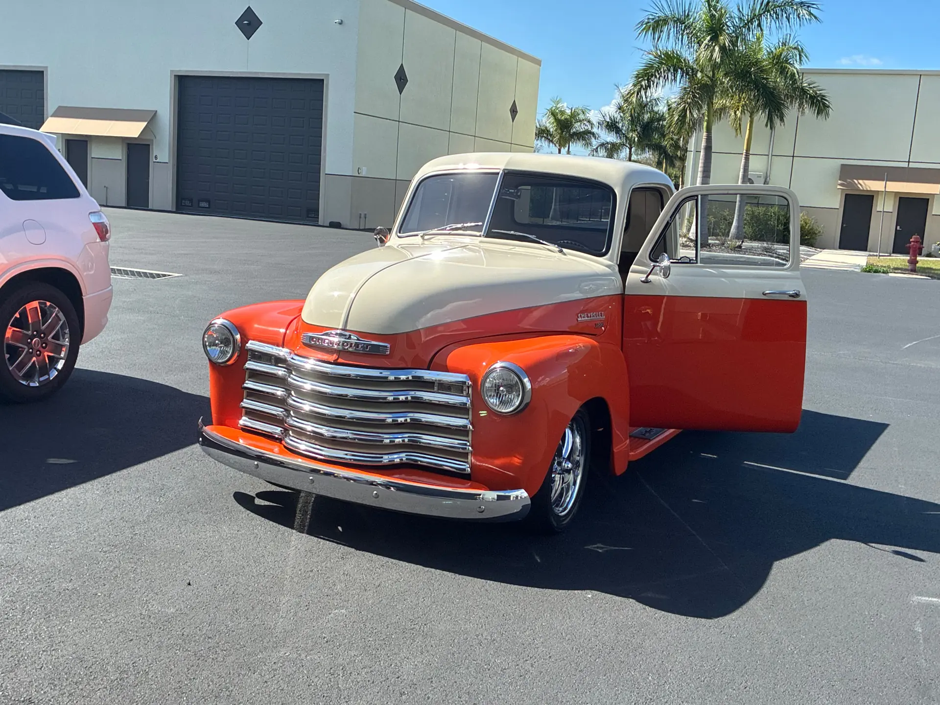 Orange and cream 1950s Chevy pickup with a deep, glossy finish after detailing.